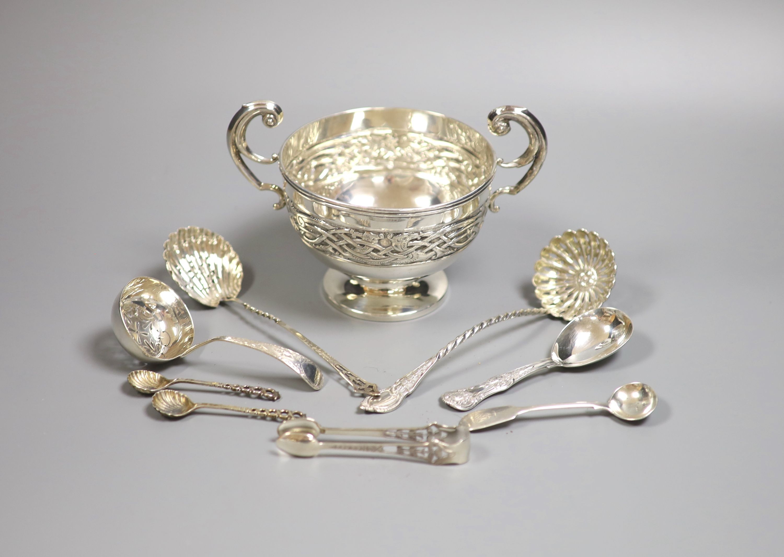 A George V silver Art Nouveau two handled bowl, Birmingham, 1912, height 11.3cm and seven items of silver flatware, 9.5oz.